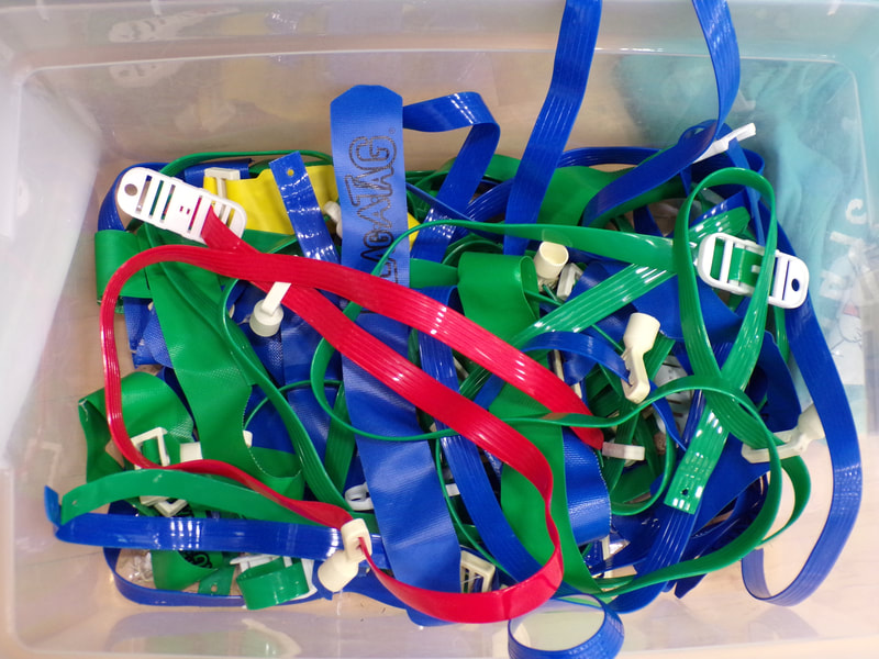 This photo demonstrates emphasis because the single red rope stands out among the blue and green ones. 